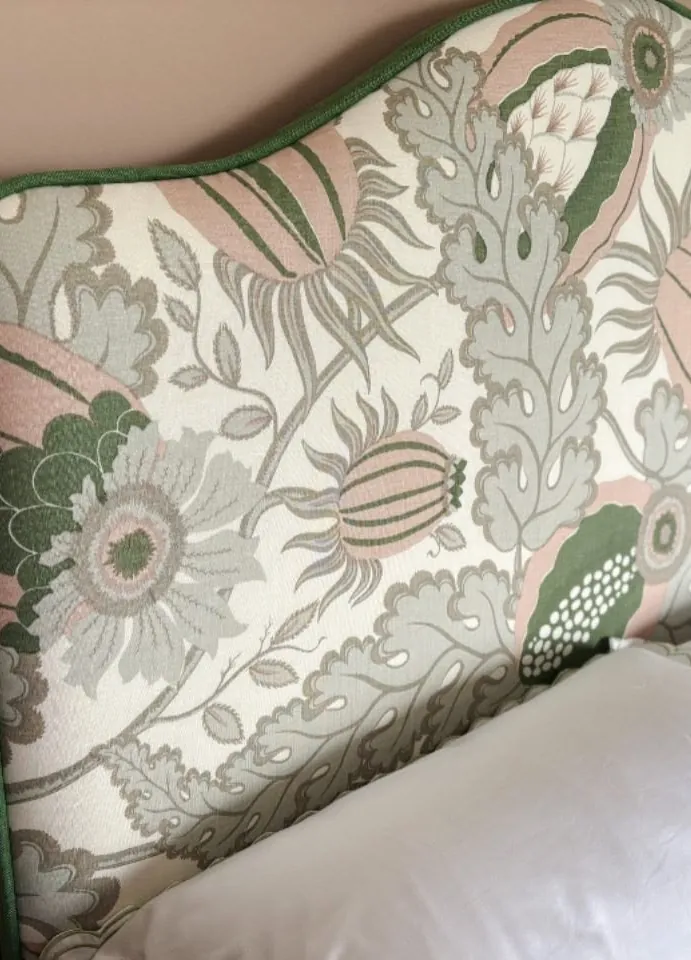 A close detail of the sage botanical linen and its contrast green piping