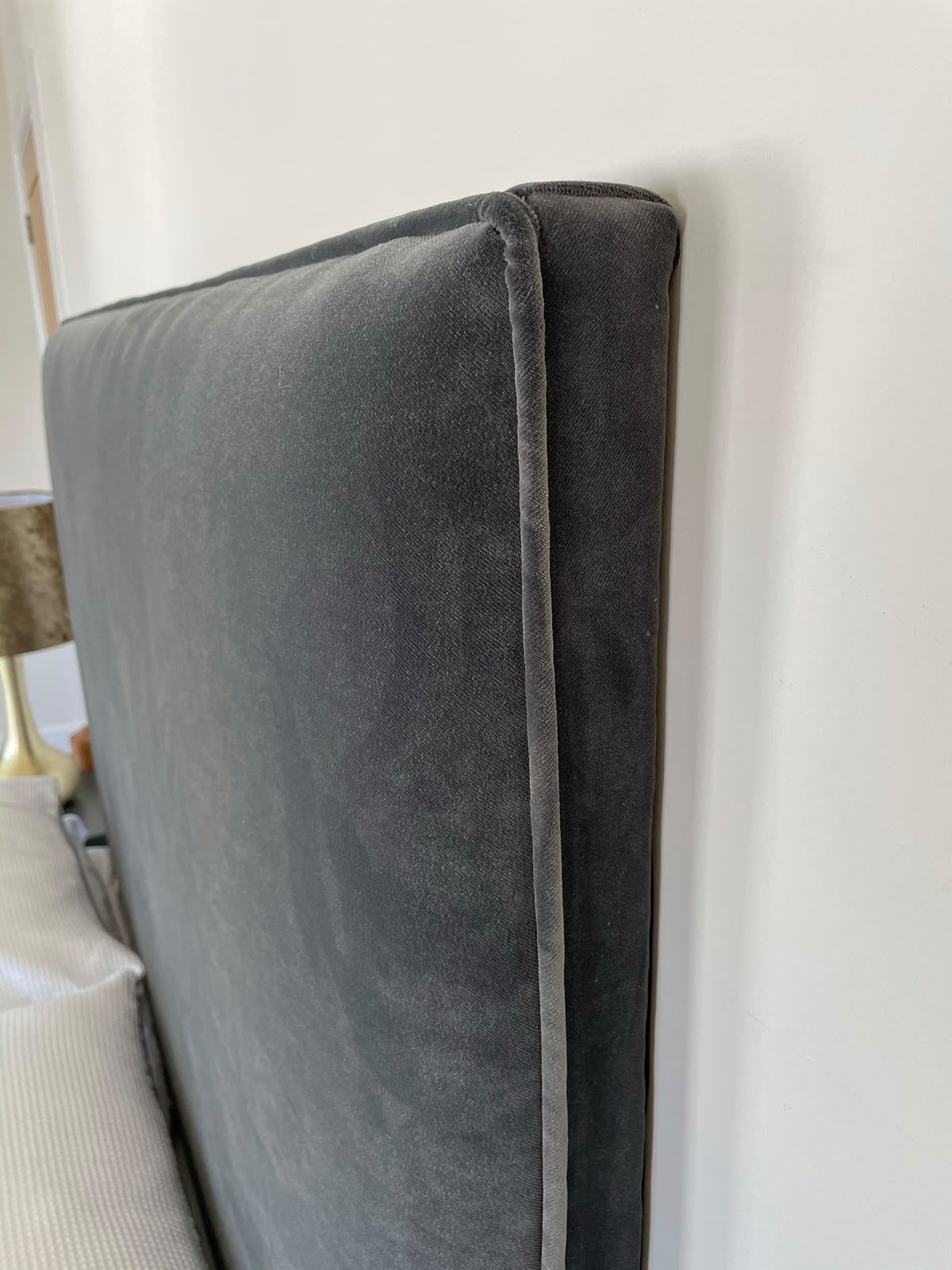 A clean straight headboard in a plain charcoal linen — sometimes less is more