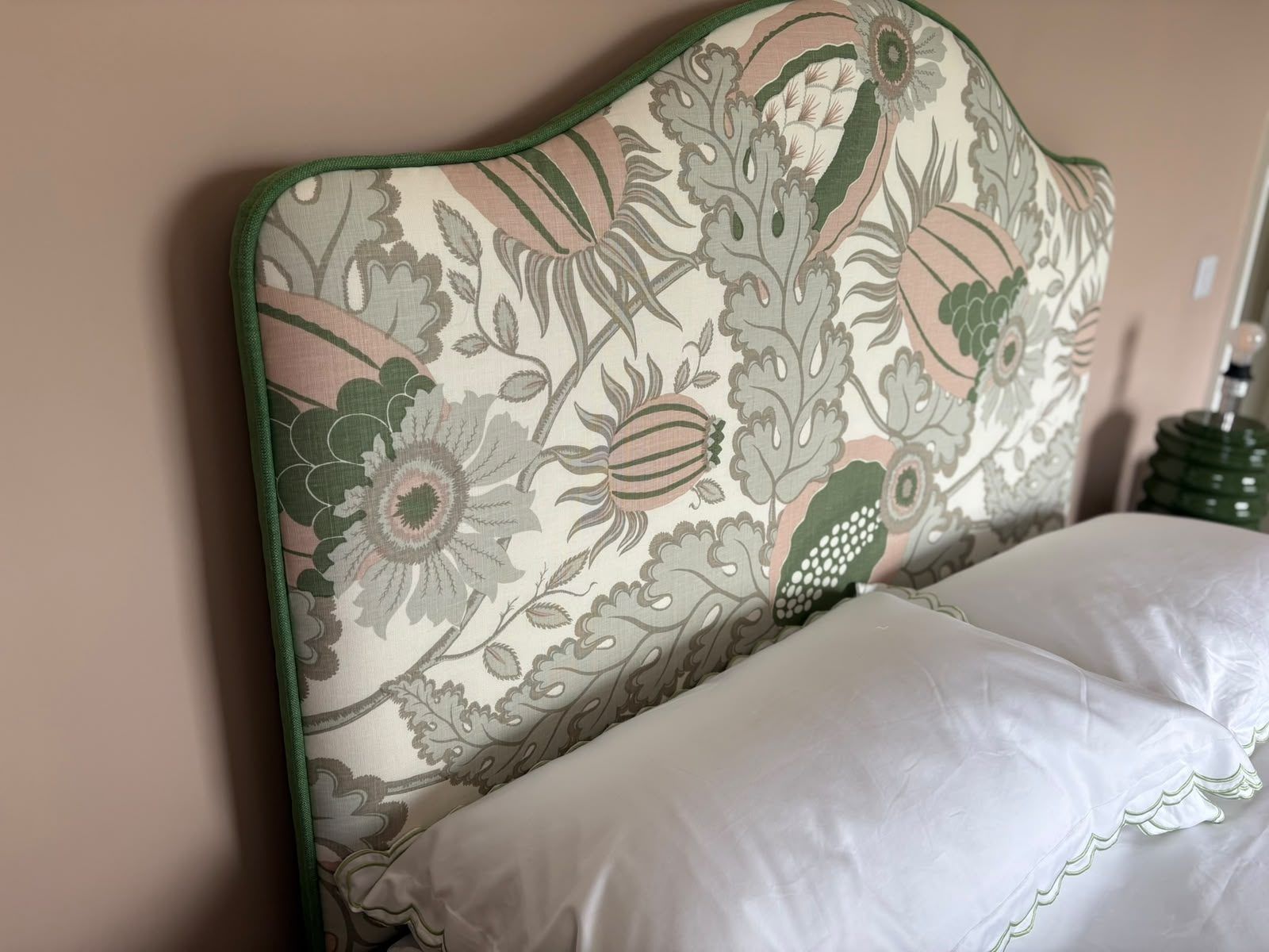 A finished shaped bespoke headboard in a Morris-style floral